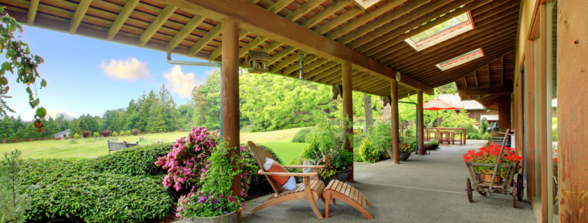 Large ranch covered porch with flowers